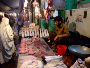 Woman in Burka at the evening meat market