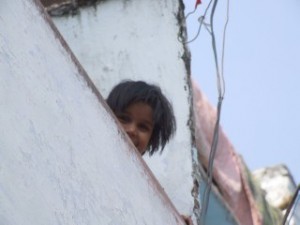 Small girl playing hide and seek in India