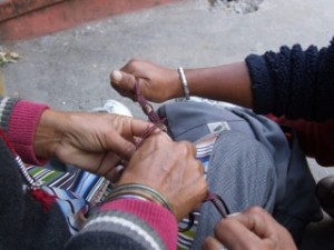 Tibetan Ladies in Nepal repairing my wrist band