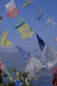 The Annapurna Mountain range and Lake Phewal Tal through Prayer flags, Nepal