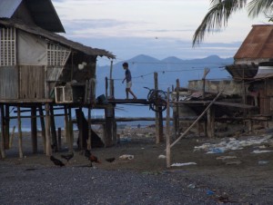 Stilt house and boy at dawn in Brooke's Point, Palawan, The Philippines (click to enlarge)