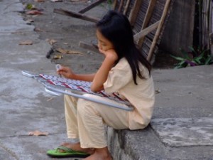 Lone Filipina Girl Playing a Xylophone