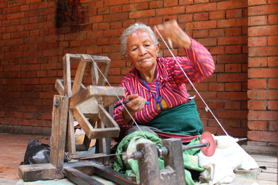 Woman spinning yarn in Nepal