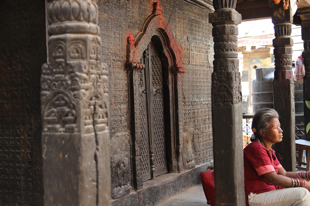 Woman sitting on Koti Mahadev Temple