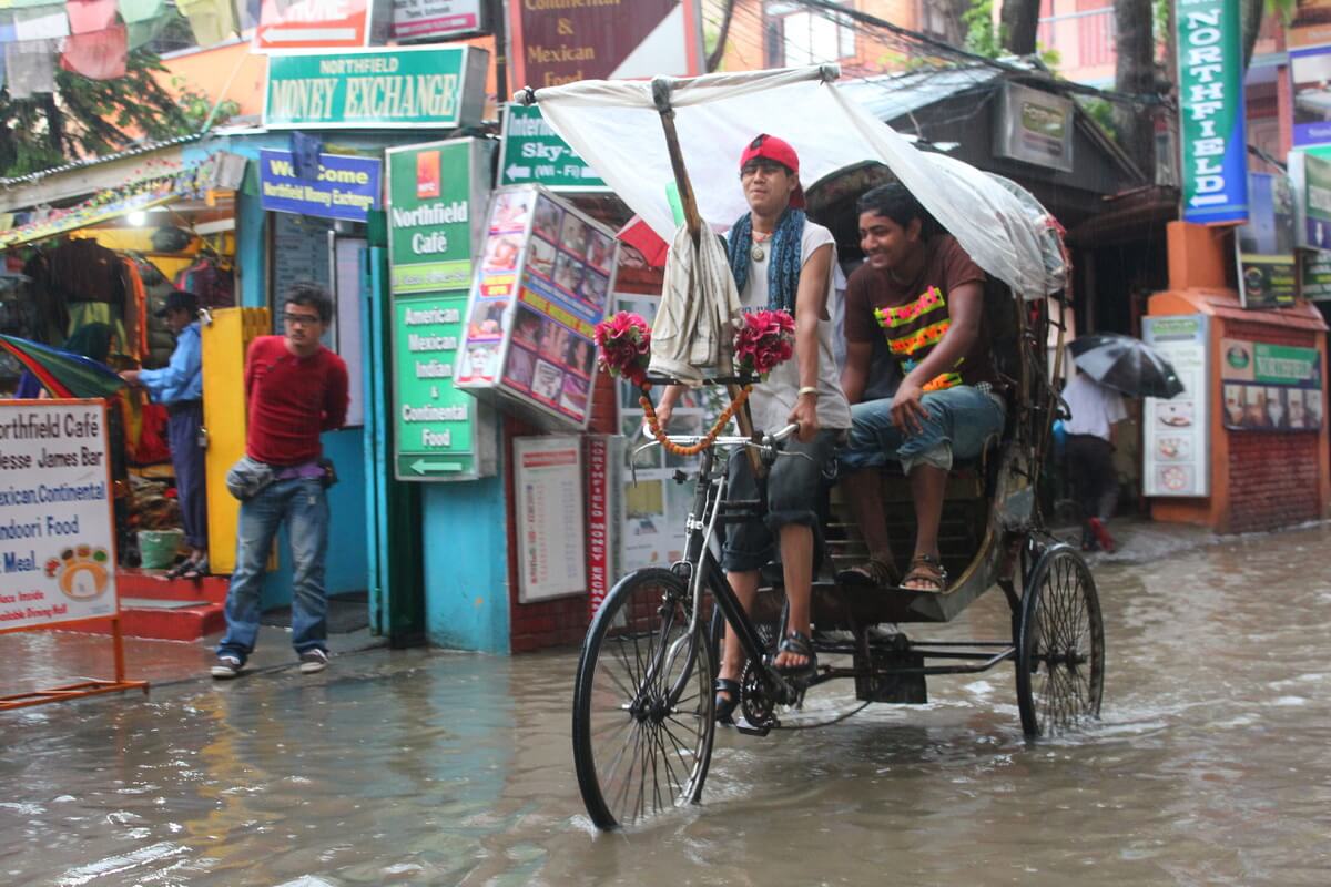 Rickshaw cycling through rain in Kathmandu